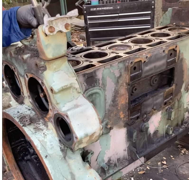 Diesel Mechanic Inspecting A Disassembled Detroit Diesel Engine